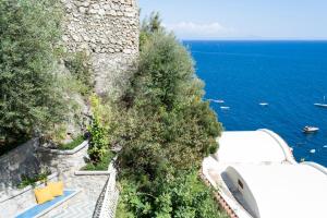 an aerial view of the ocean and a building at o' mar - Amalfi Coast Suite in Praiano
