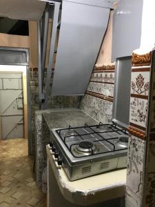 a kitchen with a stove top oven in a kitchen at La casita de Larache in Larache