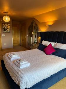 a bedroom with a large bed with towels on it at Boutique Shrewsbury Rooms in Shrewsbury