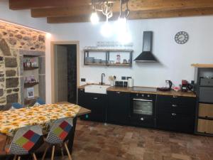a kitchen with a table and a sink and a stove at La Torre a colori in Esine