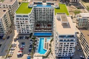an aerial view of a building with a pool at 5 Senses by Jorge in Infinity Pool & Spa Resort in Mamaia Sat/Năvodari