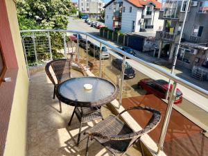 a table and chairs on a balcony with a view of a street at Къща за гости Теодора in Tsarevo +14 photos