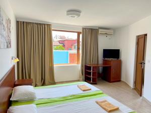 En eller flere senge i et værelse på Къща за гости Теодора