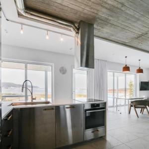 a kitchen with stainless steel appliances and a table at Villa Flamingo Lefkada in Ayía Varvára