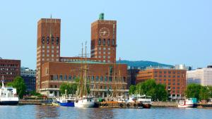 a group of boats docked in a harbor with buildings at National Theater Dormitory Mixed in Oslo