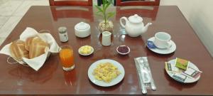 a table with breakfast foods and drinks on it at Hotel Arequipa Center in Arequipa +18 photos