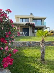 a house with pink flowers in front of it at Villa Eva Dikella in Mesimvría