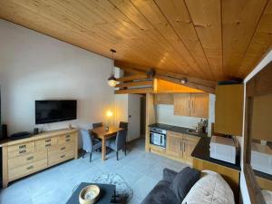 a kitchen with a couch and a table in a room at 1st floor Apartment in Central Morzine With Private Garage in Morzine +4 photos