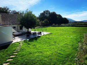 a large green field with tables and chairs in it at Casa Carvalhal do Esporão 