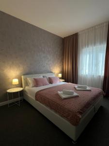 Postel nebo postele na pokoji v ubytování Apartments Aureus