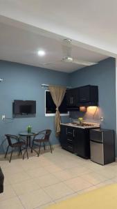 a kitchen with black cabinets and a table and chairs at Loft Brisa Del Mar #9 in Brisas de Zicatela