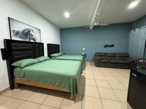 a bedroom with a bed and a couch at Loft Brisa Del Mar #9 in Brisas de Zicatela