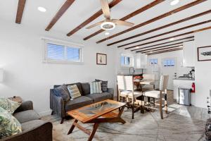 a living room with a couch and a table at Charming House & Cottage in Downtown Phoenix in Phoenix