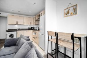 a living room with a couch and a kitchen at 2 Bedroom Apartment With Balcony - FREE PARKING in Birmingham