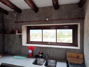 a kitchen with a sink and a window at Tierra Potrerillos in Potrerillos