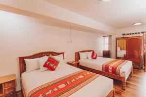ein Hotelzimmer mit 2 Betten und einem Fenster in der Unterkunft Quechua Hotel Cusco in Cusco