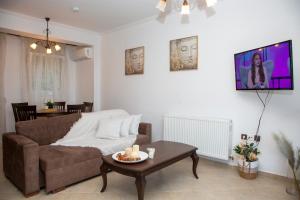 a living room with a couch and a table at Seaside Serenity House in Kavála