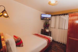 Quechua Hotel Cusco tesisinde bir odada yatak veya yataklar