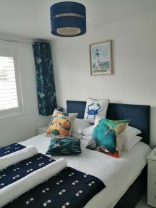 a bedroom with two beds with pillows on it at The Blue Crab in Bournemouth in Bournemouth