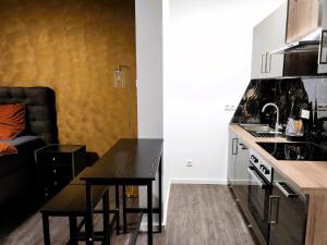 a kitchen with a table and a counter top at Hotel Valley of Business Frankfurt-Airport - BLACK LABEL STUDIO in Hofheim am Taunus