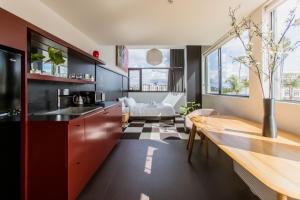 a kitchen with black cabinets and a wooden table at Abpopa Hillcrest in San Diego