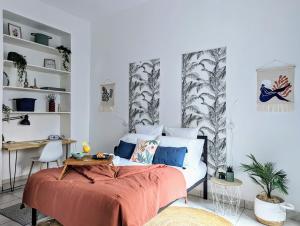 a bedroom with a bed and a desk and shelves at L'escale secrète - Emplacement central premium in Nîmes