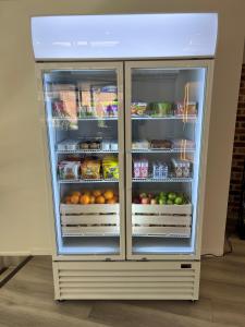 a refrigerator filled with lots of fruits and vegetables at The Select Inn Gosford in Gosford