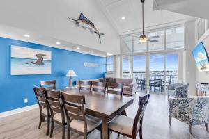 a dining room with blue walls and a table and chairs at St Croix - Downtown 4x4 Waterfront Penthouse Pool Dock Pet in Key West +41 photos