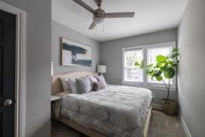 a bedroom with a bed and a ceiling fan at Red Robin Rentals - Wicker Park in Chicago