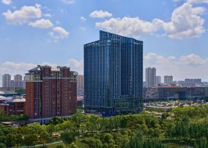a view of a city with tall buildings and trees at Hyatt Place Nantong Xinghu City Plaza in Nantong
