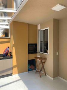 eine Küche mit einem Tisch in der Ecke eines Zimmers in der Unterkunft Condomínio pé na areia com lazer completo - PCD in Barra Velha + 16 Fotos