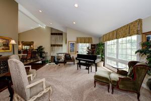 a living room with a grand piano and chairs at The Sanctuary in Laguna Hills