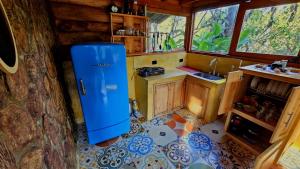 a kitchen with a blue refrigerator in a room at Beehouse Mandala in Guarne