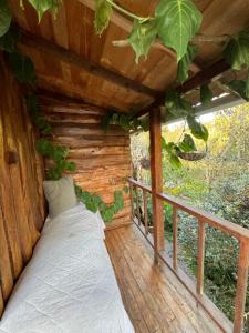 a bed on the porch of a tree house at Beehouse Mandala in Guarne +5 photos