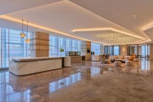 a lobby with a reception desk in a building at Hyatt Place Nantong Xinghu City Plaza in Nantong