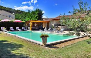 a swimming pool in the yard of a house at La Villa Du Colombier in Barbentane