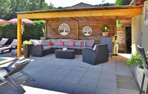 a patio with couches and a table and chairs at La Villa Du Colombier in Barbentane +30 photos
