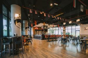 a restaurant with tables and chairs and a bar at Holiday Inn Abu Dhabi by IHG in Abu Dhabi