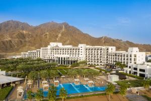 an aerial view of a hotel with mountains in the background at InterContinental Fujairah Resort by IHG in Al Aqah