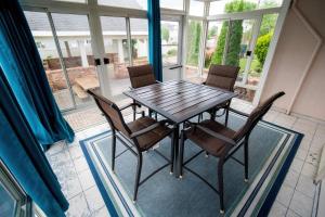 a dining room with a wooden table and chairs at Spacious Home In A Quiet Neighborhood in Atlantic City +11 photos