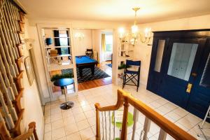 a hallway with a staircase and a blue door at Spacious Home In A Quiet Neighborhood in Atlantic City