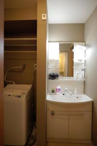 a small bathroom with a sink and a mirror at Osaka - House - Vacation STAY 16353 in Osaka