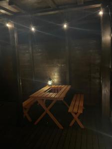 a wooden table and bench in a dark room at Lulu in Minami Alps