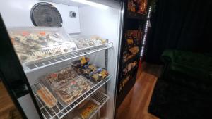 an open refrigerator filled with food and other items at Hotel Asturias in Viña del Mar