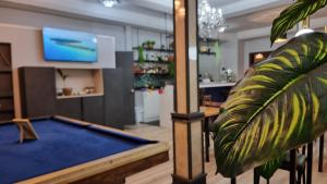 a living room with a pool table and a tv at Hotel Asturias in Viña del Mar