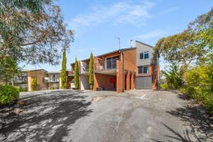 an empty driveway in front of a house at Deadwood Den - Luxurious 3BR Townhouse l Lake Views l Bath l WiFi in Jindabyne