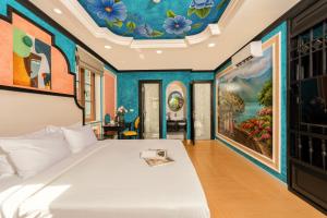 a bedroom with a bed and a painting on the ceiling at Hoàng Hôn Tím Boutique Hotel in Phú Quốc