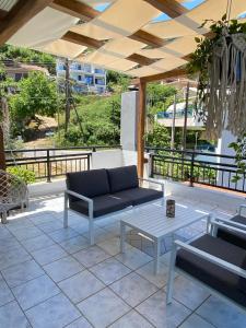 a patio with a couch and a coffee table at LASKARINA'S HOUSE in Skala Potamias
