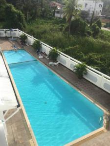 an overhead view of a large blue swimming pool at 2 Somphong Ban Amphur Beach Thailand Condotel in Na Jomtien +10 photos