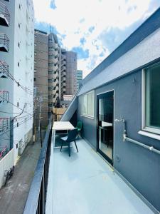 a balcony with a table and a desk on a building at home shinjuku west301 in Tokyo